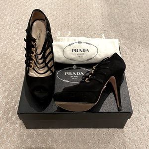 Prada peep toe platform heel in black.